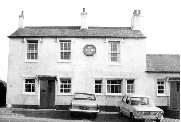 Black and white photograph of a plain two-storey whitewashed house with sash windows, an octagonal sign reading The Museum Inn between the upper windows and two 1970s cars parked in front