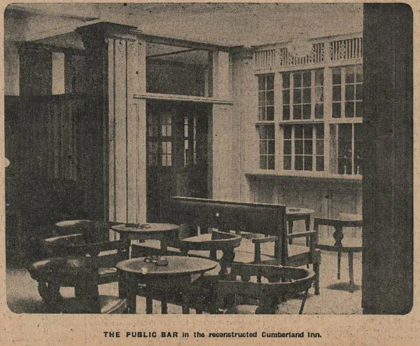 Newspaper photograph of a panelled bar room with small round tables and wooden armchairs, a tall settle, glazed panelled doors and a wide window with leaded upper lights