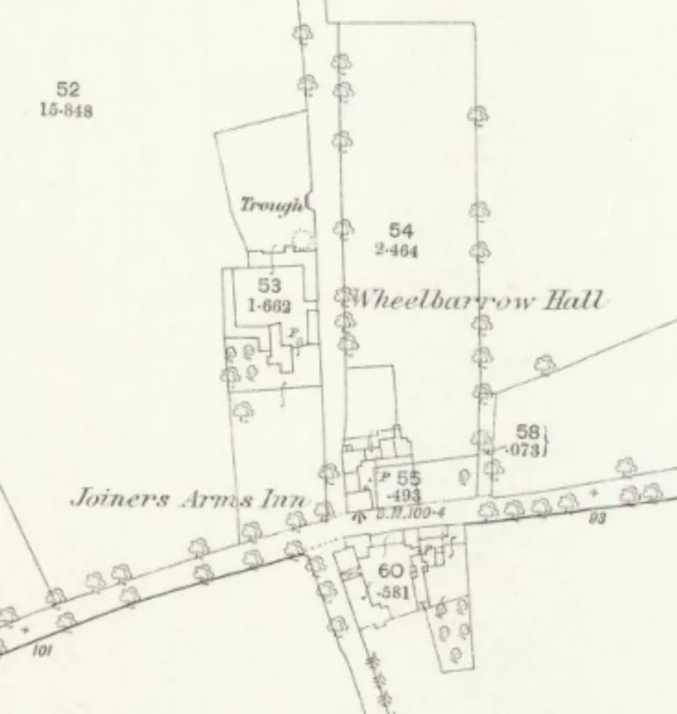 Detail of an old Ordnance Survey map: a crossroads on a tree-lined main road, with Wheelbarrow Hall to the north, a cluster of buildings on the corner and the words Joiners Arms Inn beside them